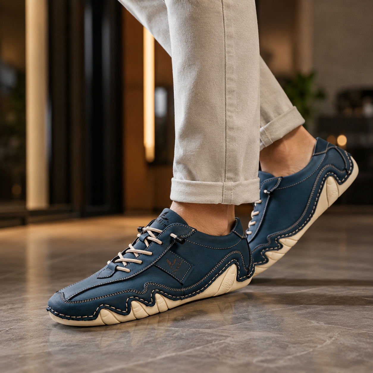 Riviera Hand-Stitched Leather Sneaker in blue, worn