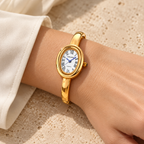 Aurelia Bracelet Watch in Gold worn with an ivory blouse