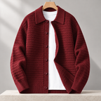 Cesare Waffle-Knit Cardigan in Brick Red on a wooden hanger