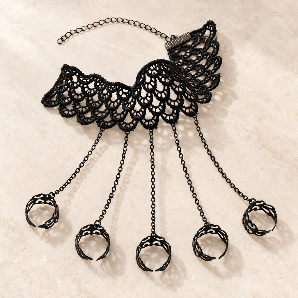 Noemi Hand Chain flat lay with five filigree rings and adjustable black lace cuff